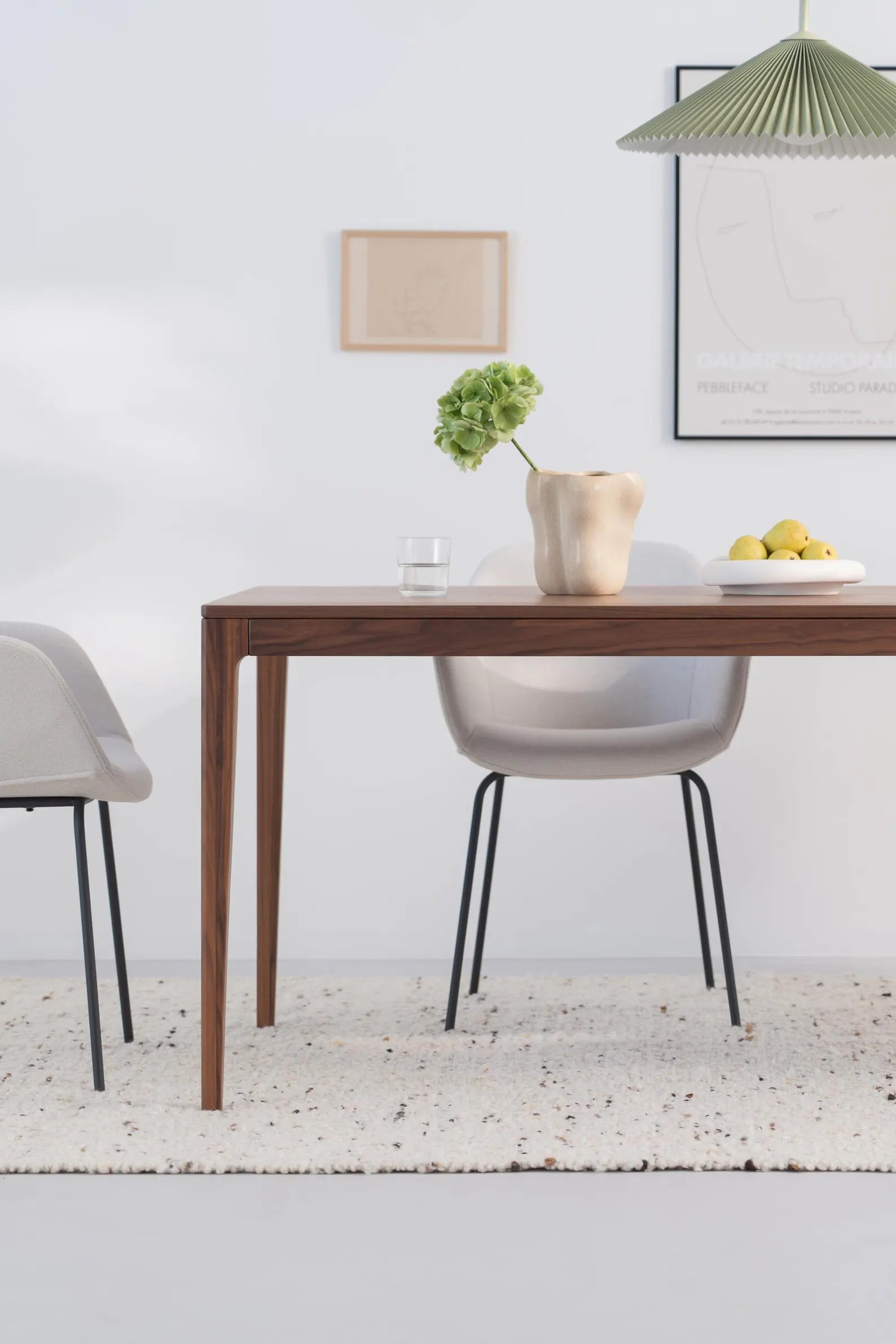 Solid walnut dining table with natural finish and minimalist lines, ideal for gatherings, seats 6 to 8 people