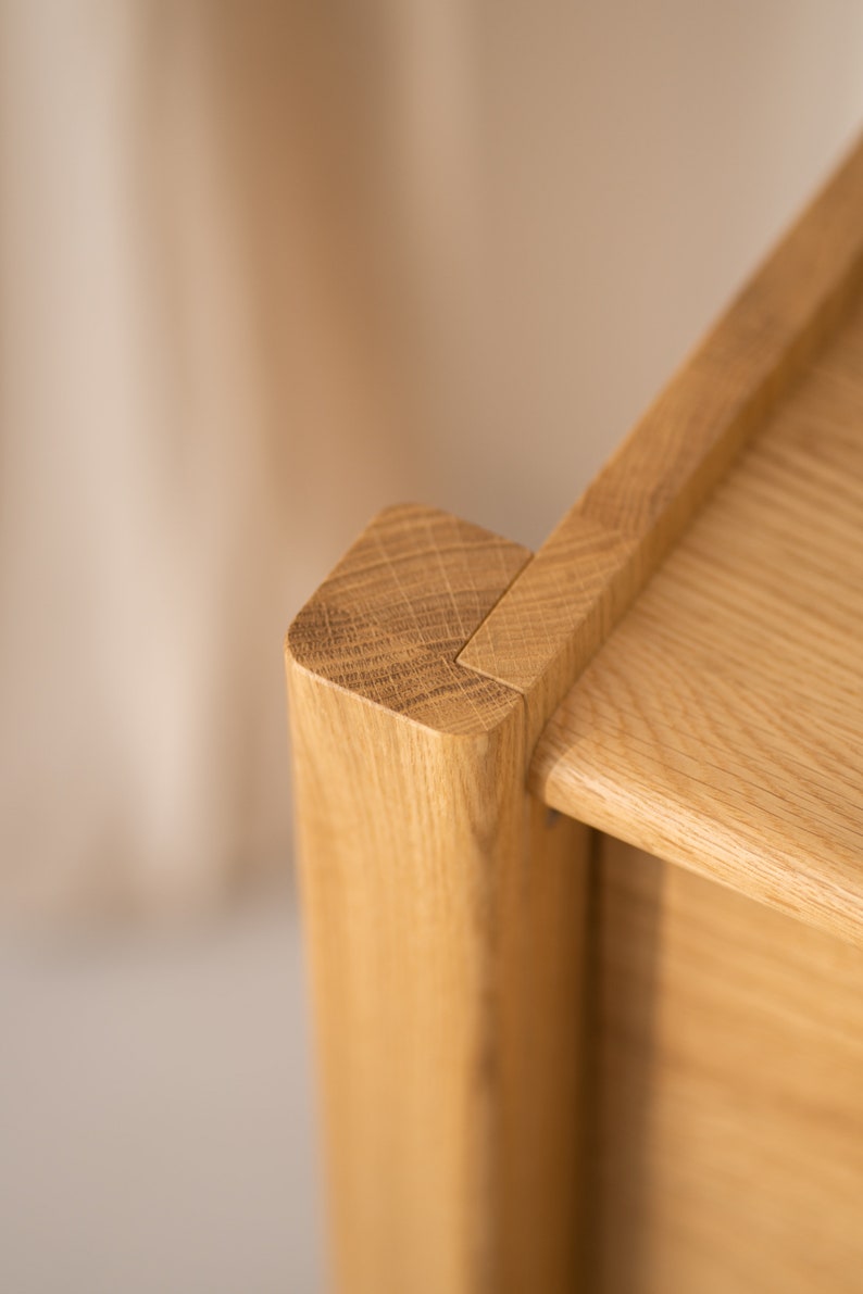 Wide oak TV console with slatted doors, drawers, and cable management
