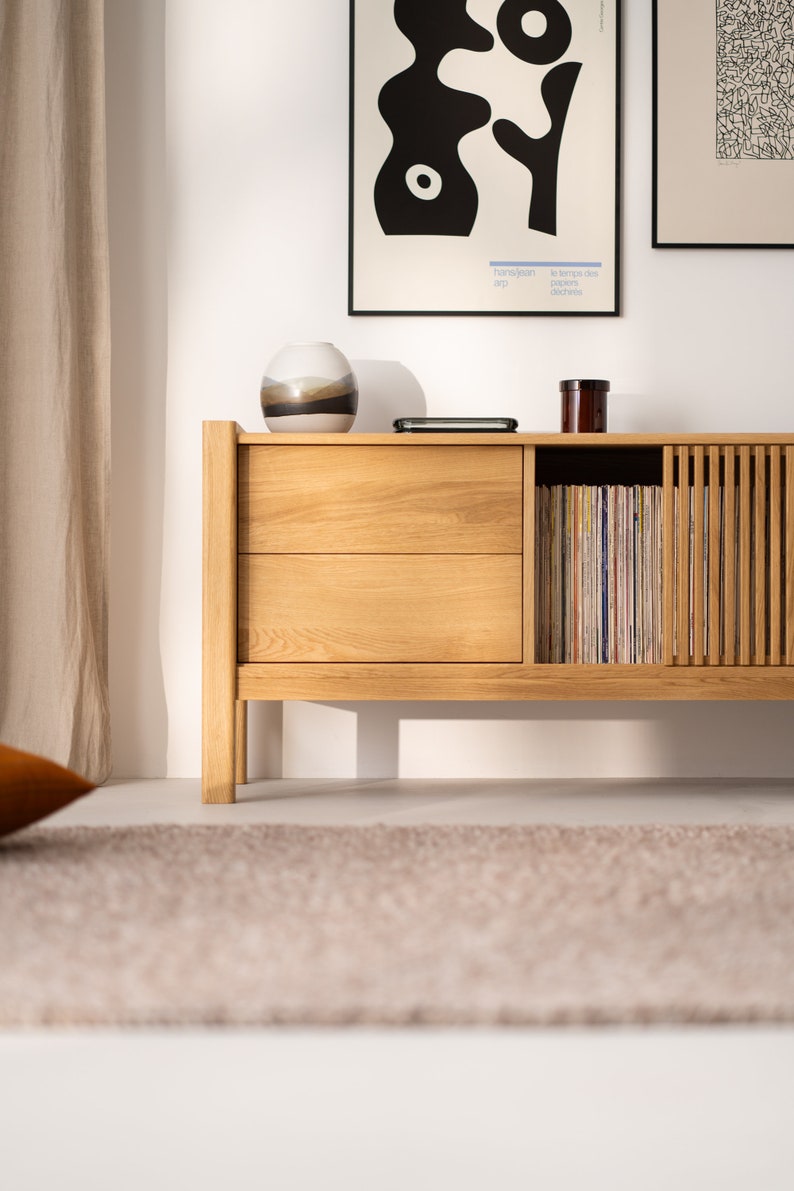 Wide oak TV console with slatted doors, drawers, and cable management