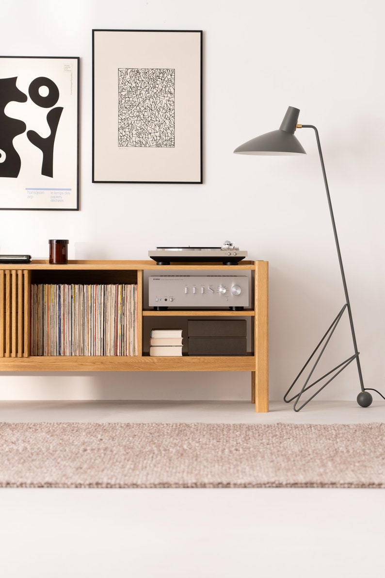 Wide oak TV console with slatted doors, drawers, and cable management