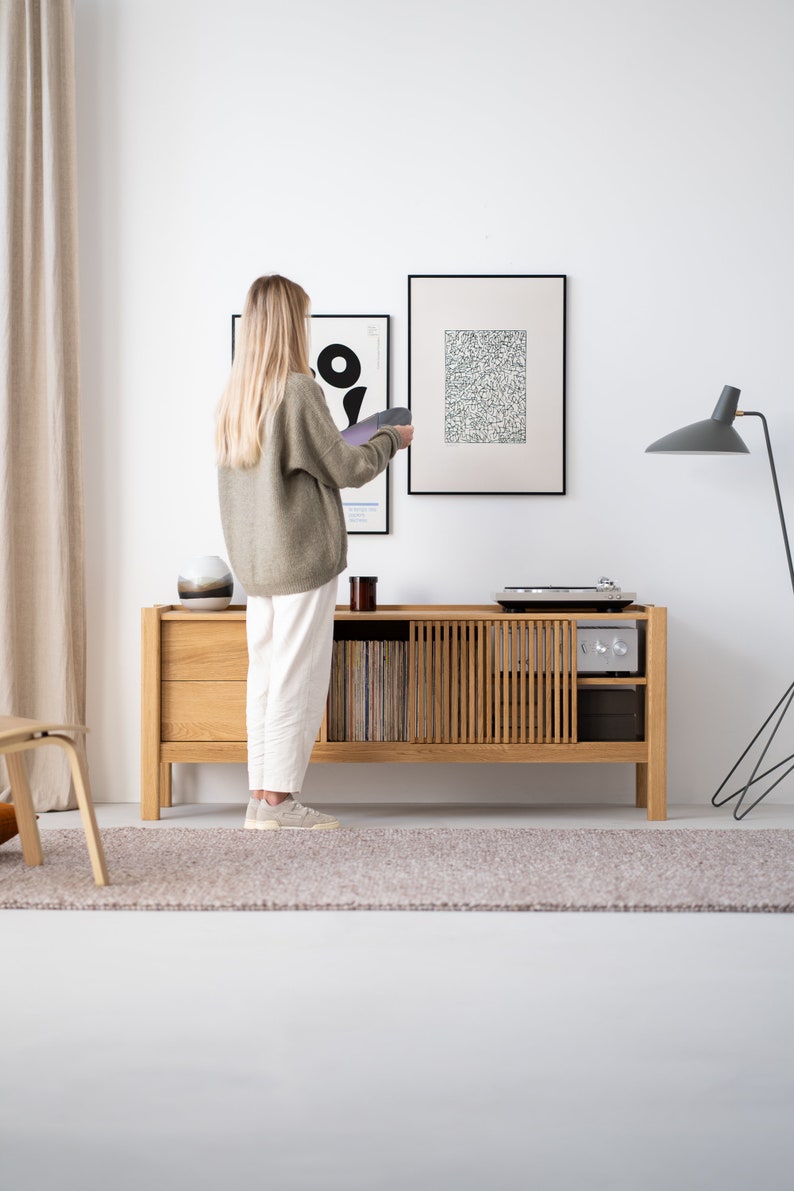 Wide oak TV console with slatted doors, drawers, and cable management