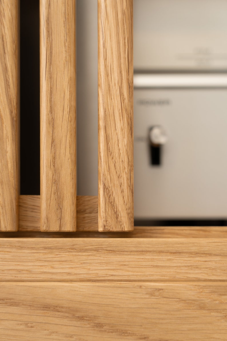 Low-profile media console in oak with sliding front panel