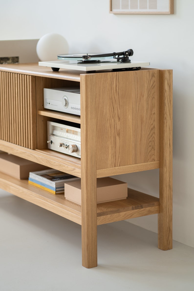 Low-profile media console in oak with sliding front panel #material_solid-oak