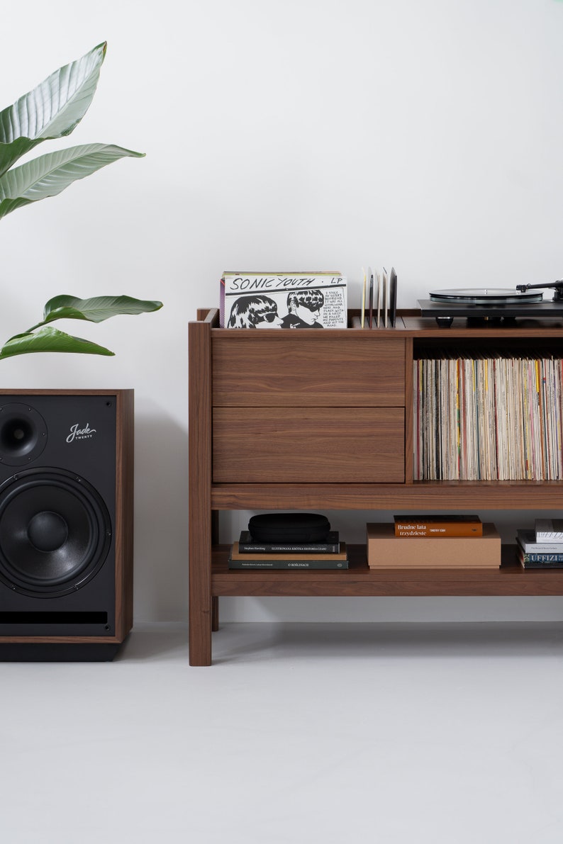 Low-profile media console in walnut with sliding front panel