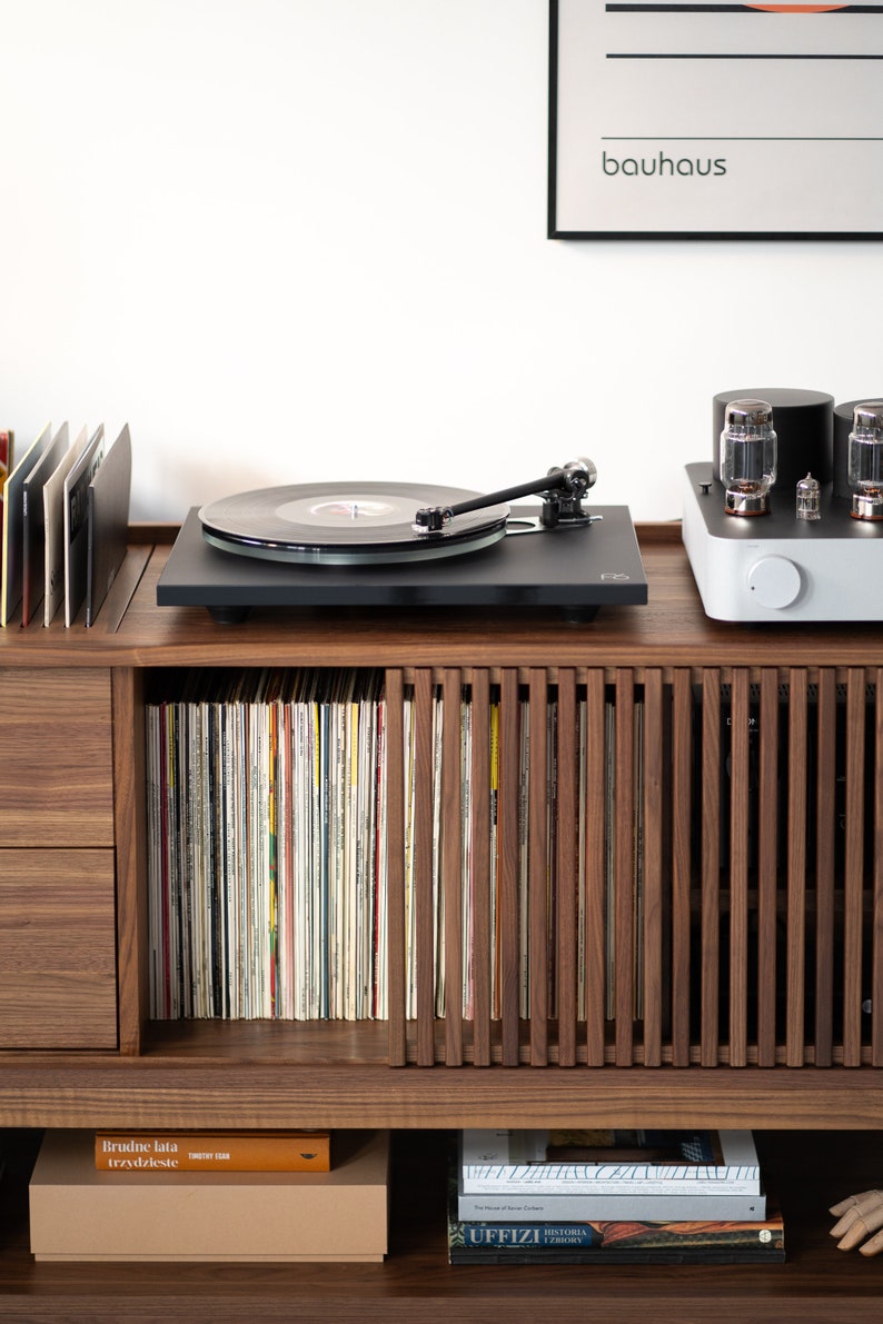 Low-profile media console in walnut with sliding front panel