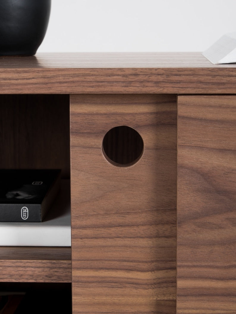 KUUB TV console with two side-sliding doors, walnut veneer, customizable wood fronts, cable holes, and hardwax oil finish