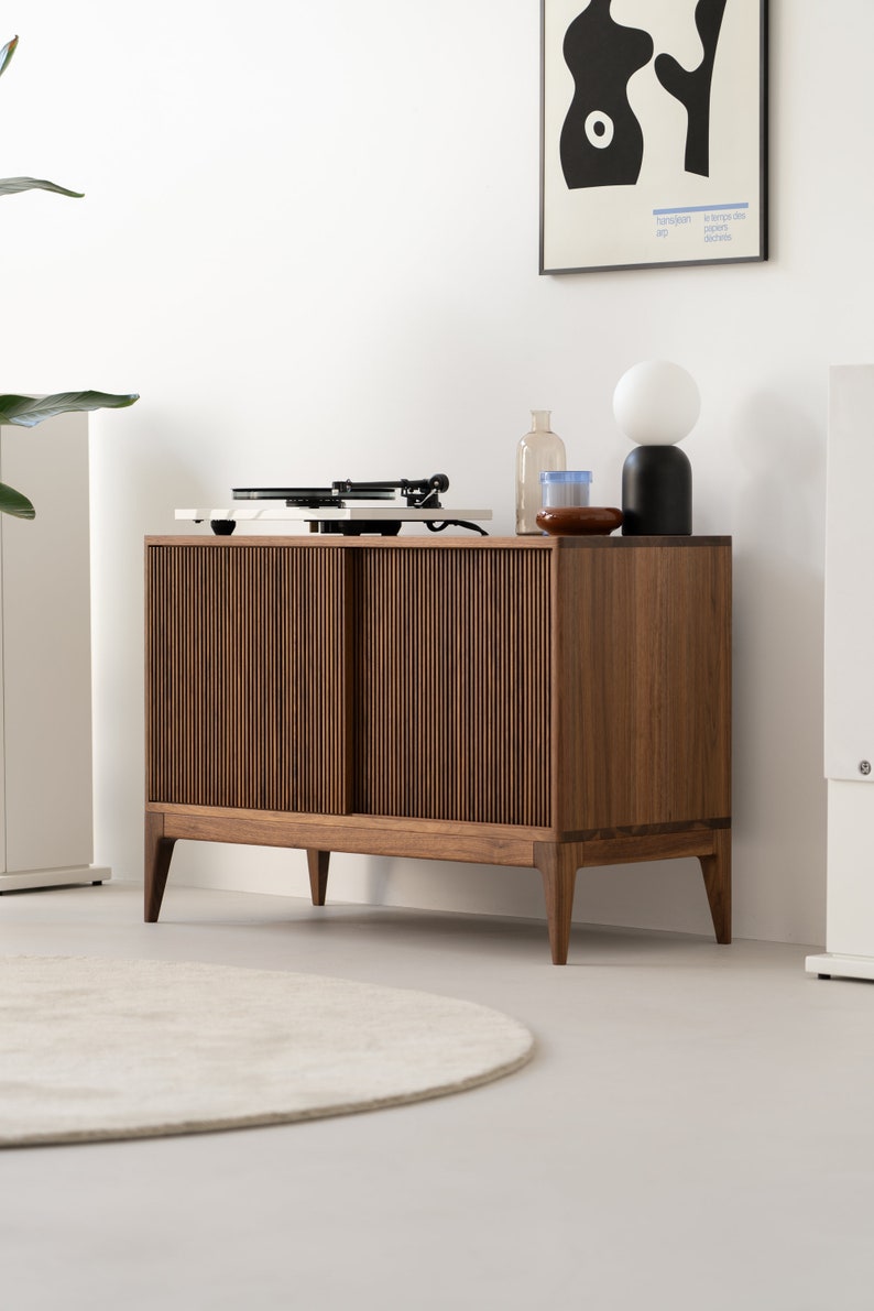 Solid walnut media console with geometric openwork front and adjustable compartments