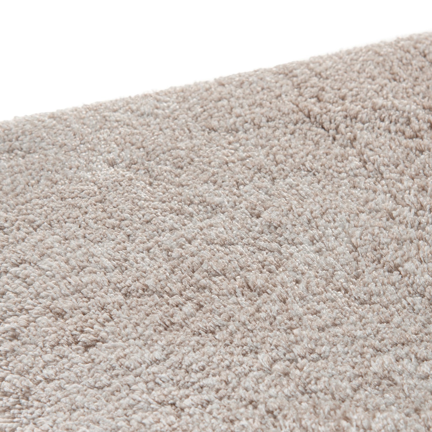 Cozy area rug made from 100% Tencel with velvety soft surface, anti-slip backing, and available in beige