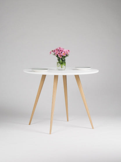 Round dining table with four solid oak legs and MDF finish
