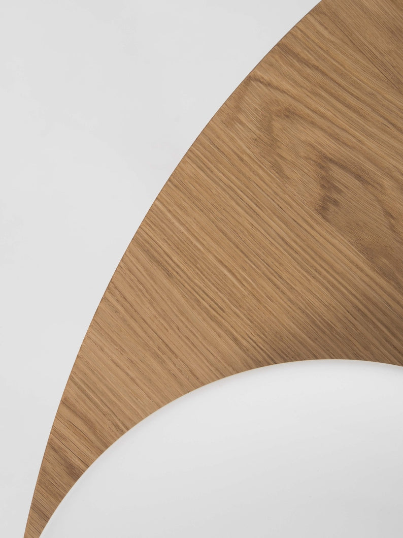 Round dining table with four solid oak legs and natural wood finish