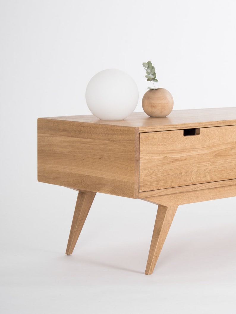 HEIM TV stand with two drawers and center open shelf, low-profile oak design with cable holes and customizable fronts