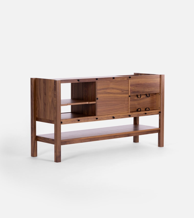 Low-profile media console in walnut with sliding front panel 