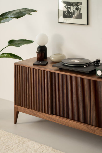Wide walnut media console with openwork front and customizable compartments 
