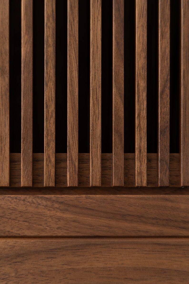 Wide walnut media console with openwork front and customizable compartments 