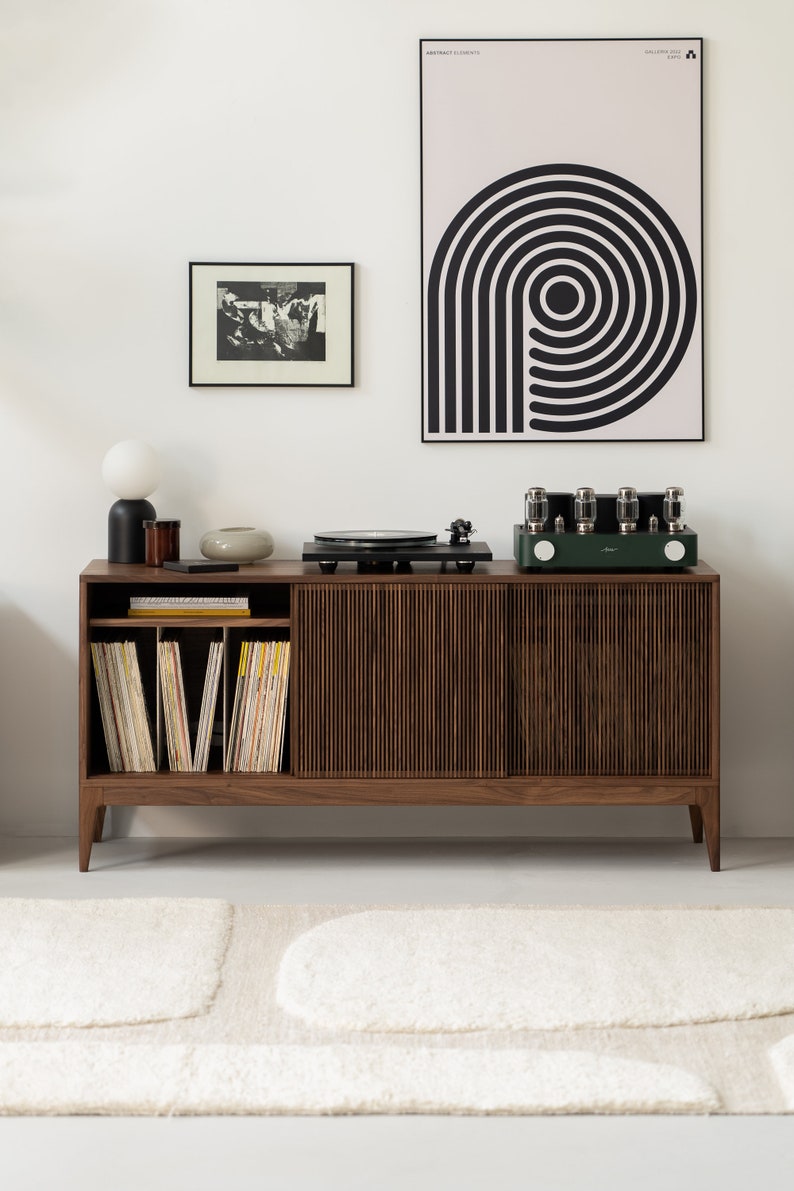 Wide walnut media console with openwork front and customizable compartments 