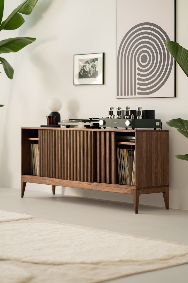 Wide walnut media console with openwork front and customizable compartments