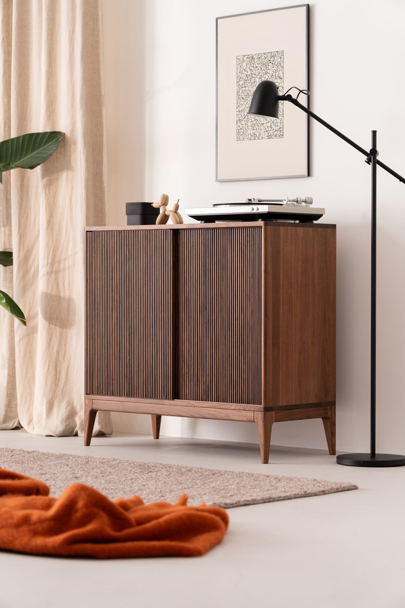 Tall walnut media console with hand-cut slatted front and adjustable compartments